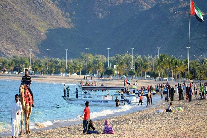 Experience the charm of Khor Fakkan Village’s sandy shores where families enjoy leisurely beach days camel rides and picturesque views of the surrounding mountains and inviting waters.